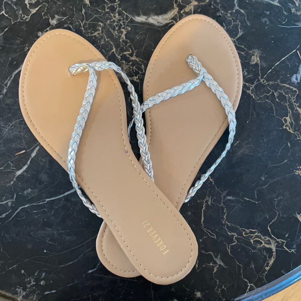 Braided silver flip flops